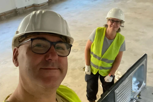 Robert on site with a second person — the two-person buddy system used for fire-door repair and installation work