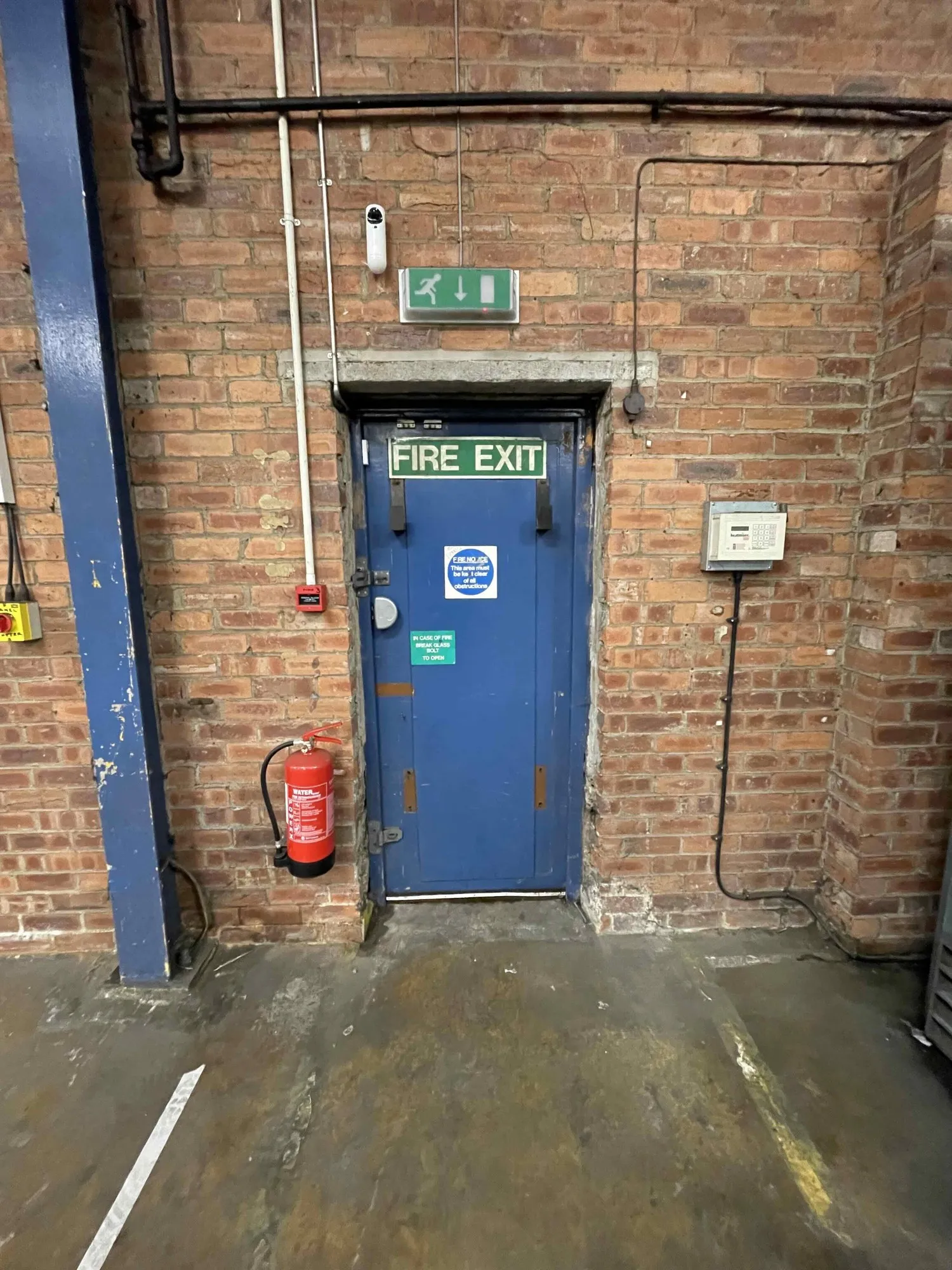 Worn blue internal steel exit door before replacement